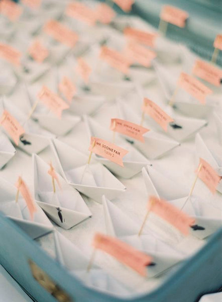 Paper boats are easy to make, but they give a really nice touch to a nautical or beach-themed wedding.