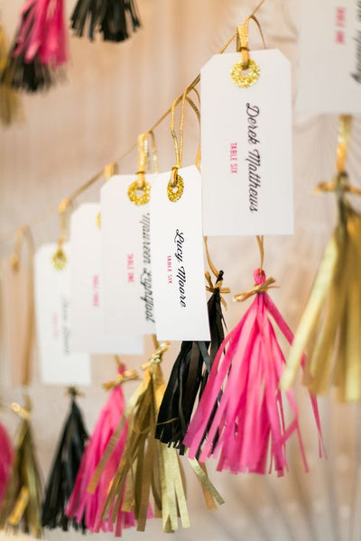 Get your guests in a festive mood with the help of these tassel-decorated escort cards.