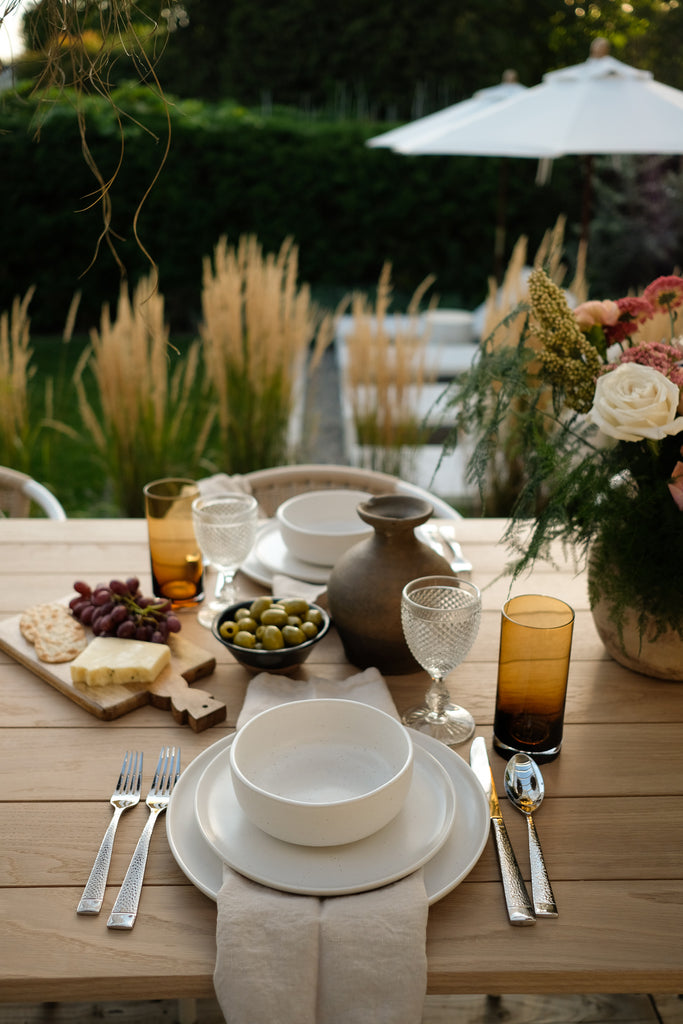 Ekmek bread board and Jiro Clay Bowl set on a dinner table with Fable dishware