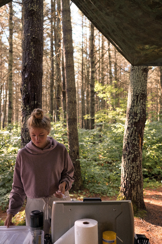 Making coffee and breakfast under a tarp with a coleman portable propane stove while camping at Algonquin Park