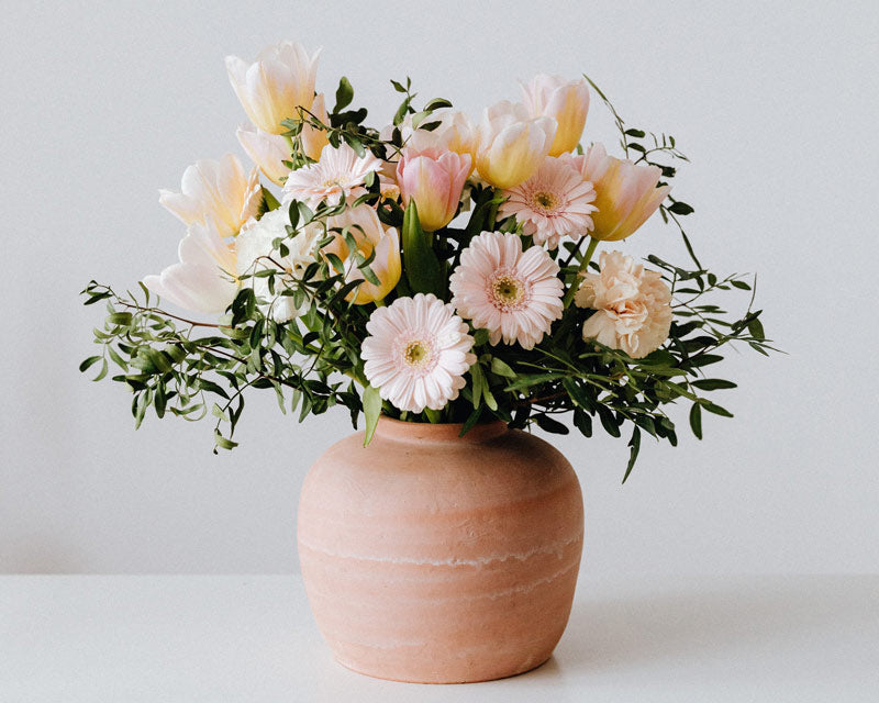Flower bouquet in a round ceramic vase