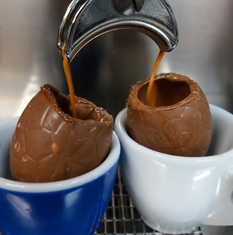 Two chocolate easter eggs filling up with freshly brewed espresso.