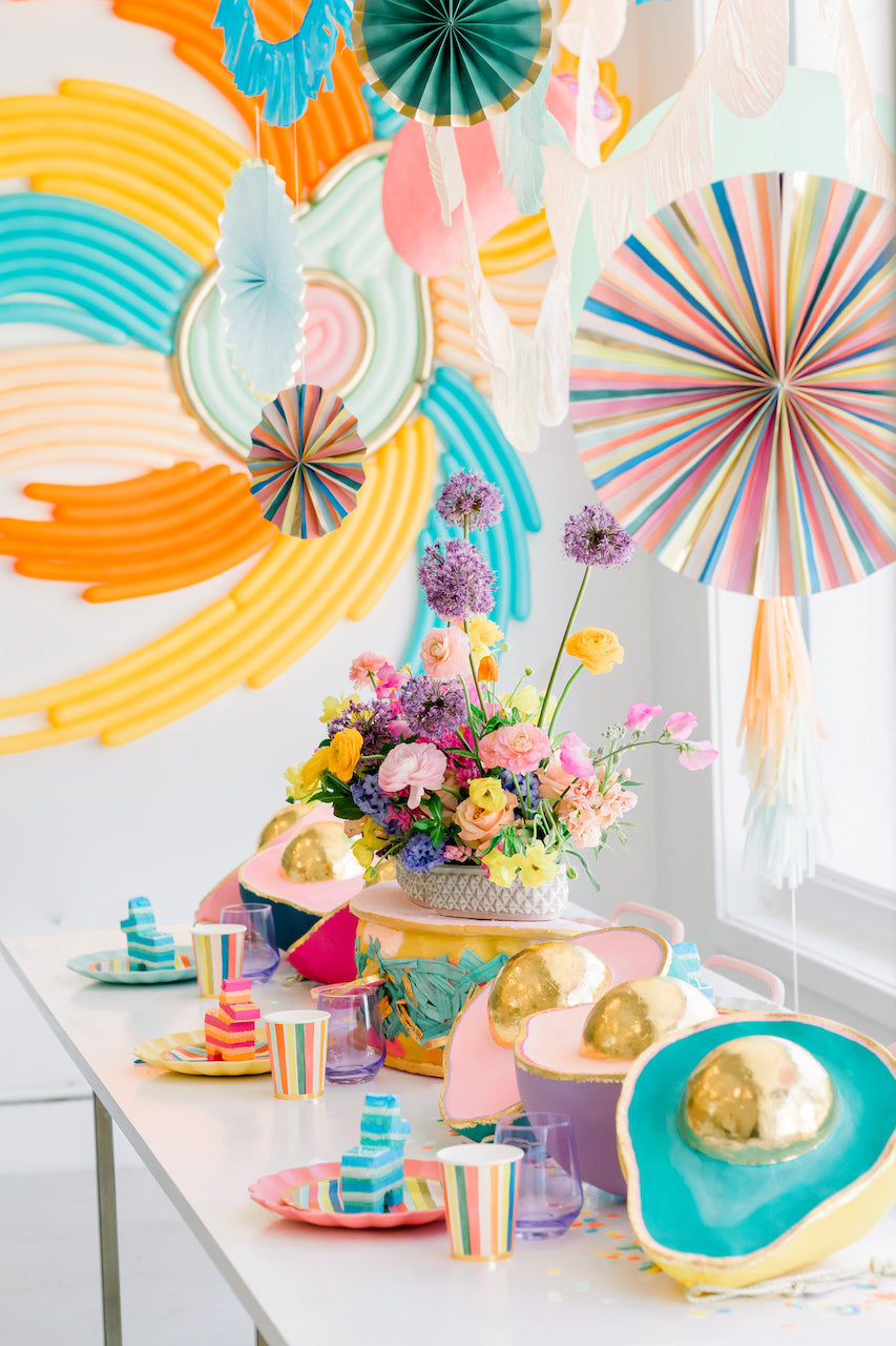 Party fans and avocado decorations for a Cinco de Mayo celebration. 