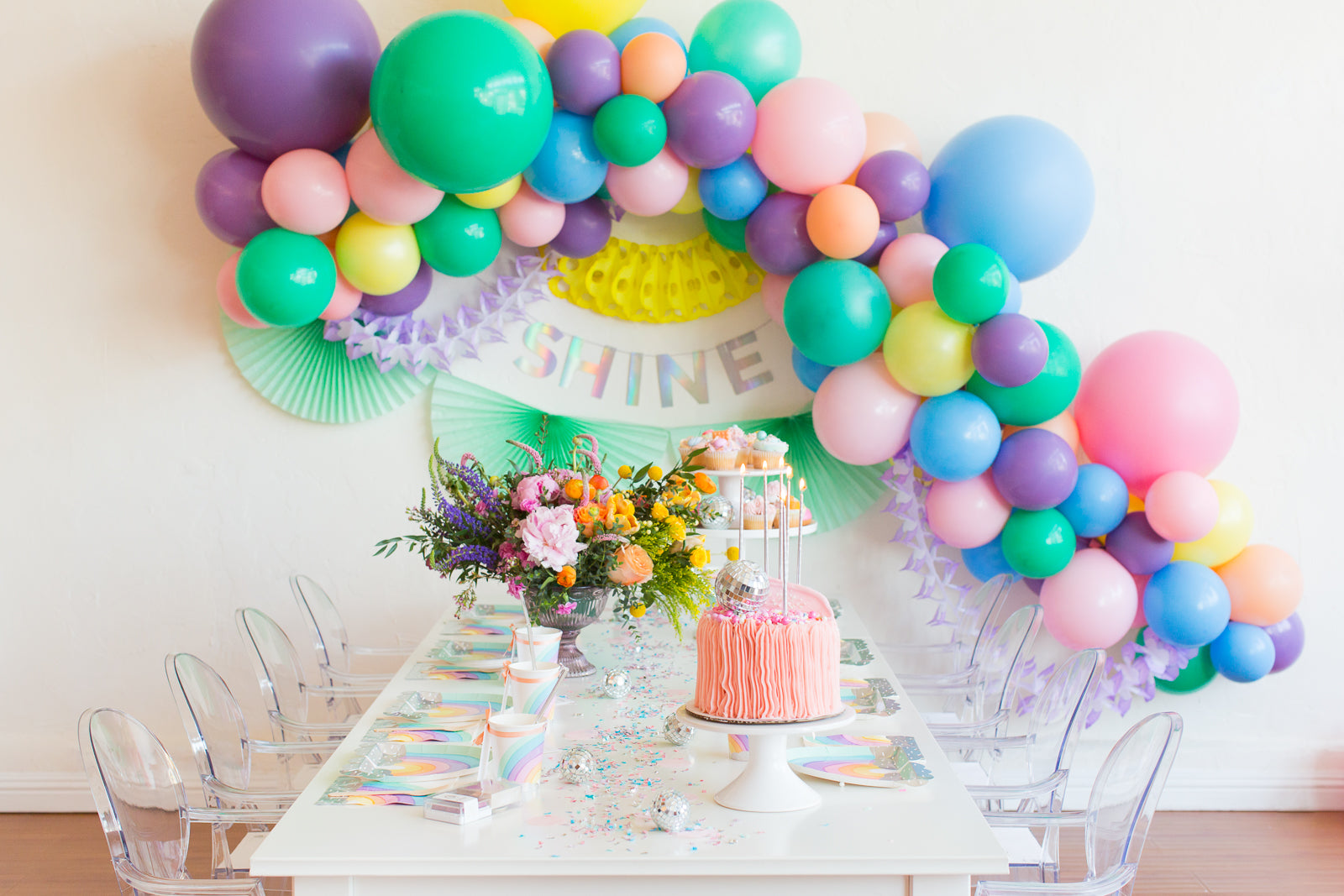 Rainbow party decorations set up for a girl's rainbow birthday party.