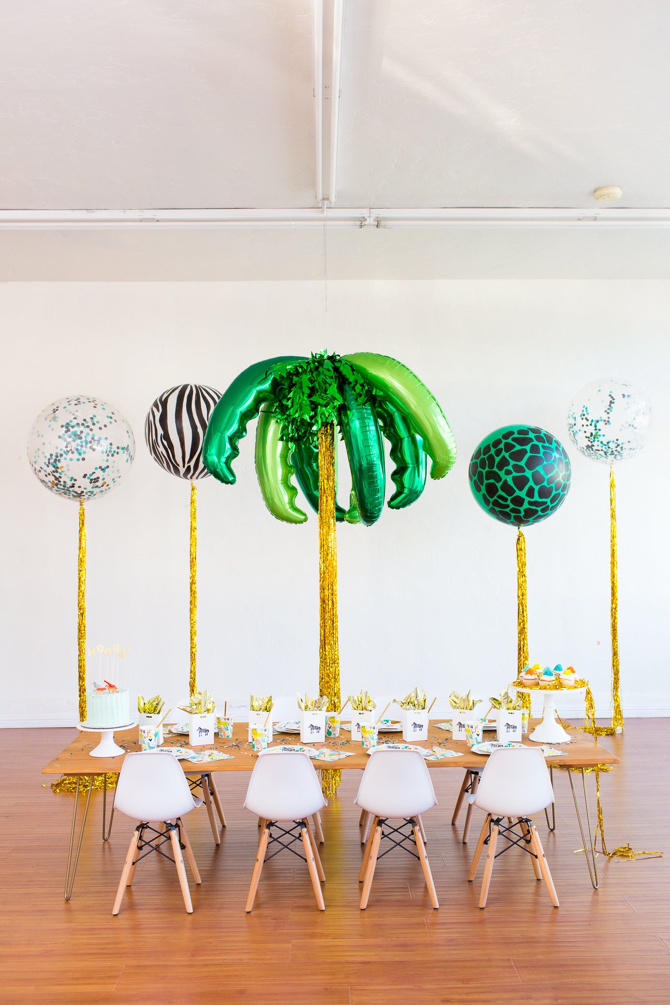 Palm tree balloons and jungle theme balloons for a safari birthday party. 