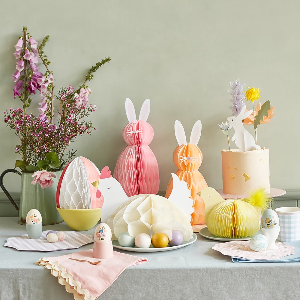 Easter honeycomb table decorations in the shape of Easter bunnies, Easter eggs, and a chicken. 
