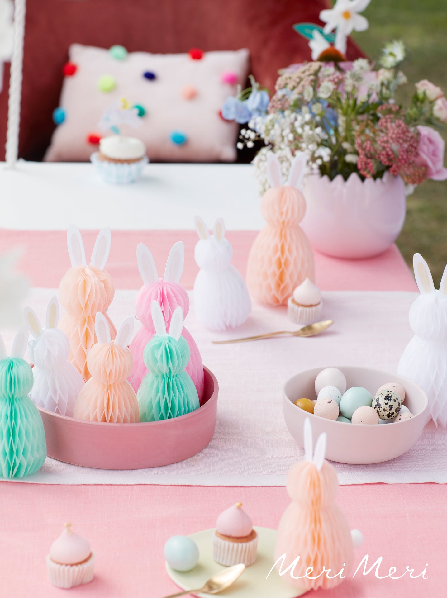 Easter bunny honeycomb decorations displayed on an Easter party table. 