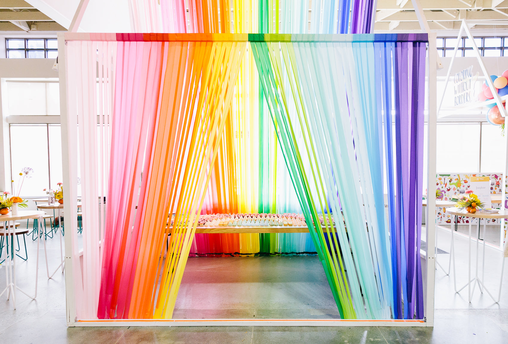 Rainbow party decoration idea using rainbow streamers. 