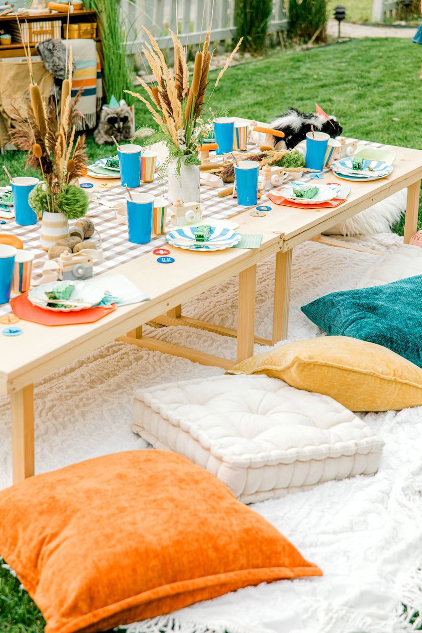 Camping-themed birthday party table set up. 