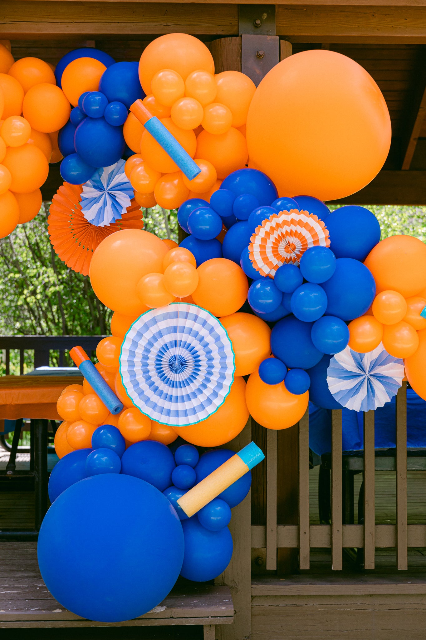 Nerf birthday party decoration ideas using party fans and darts.