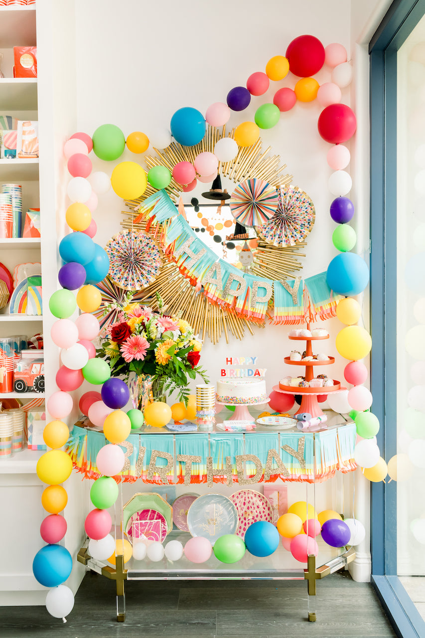 Birthday party decorations and supplies displayed at Bonjour Fête