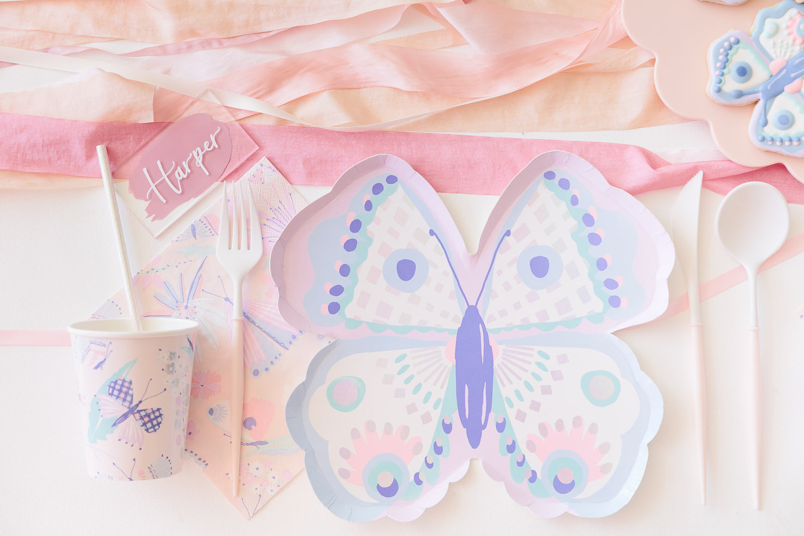 Butterfly party supplies set out for a girl's birthday party.