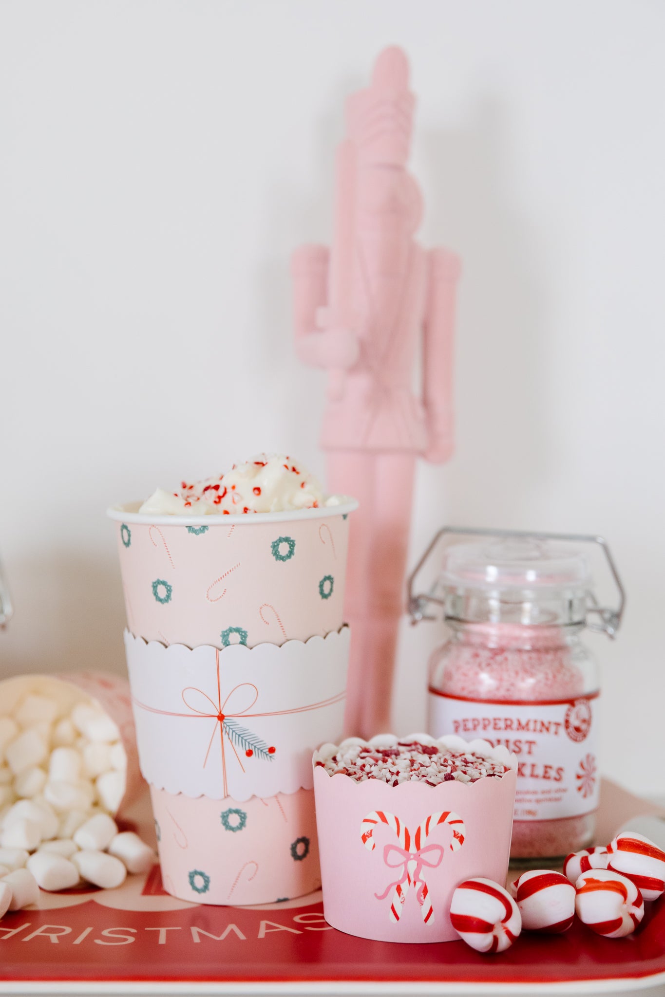 Peppermint hot chocolate in pink Christmas party supplies.