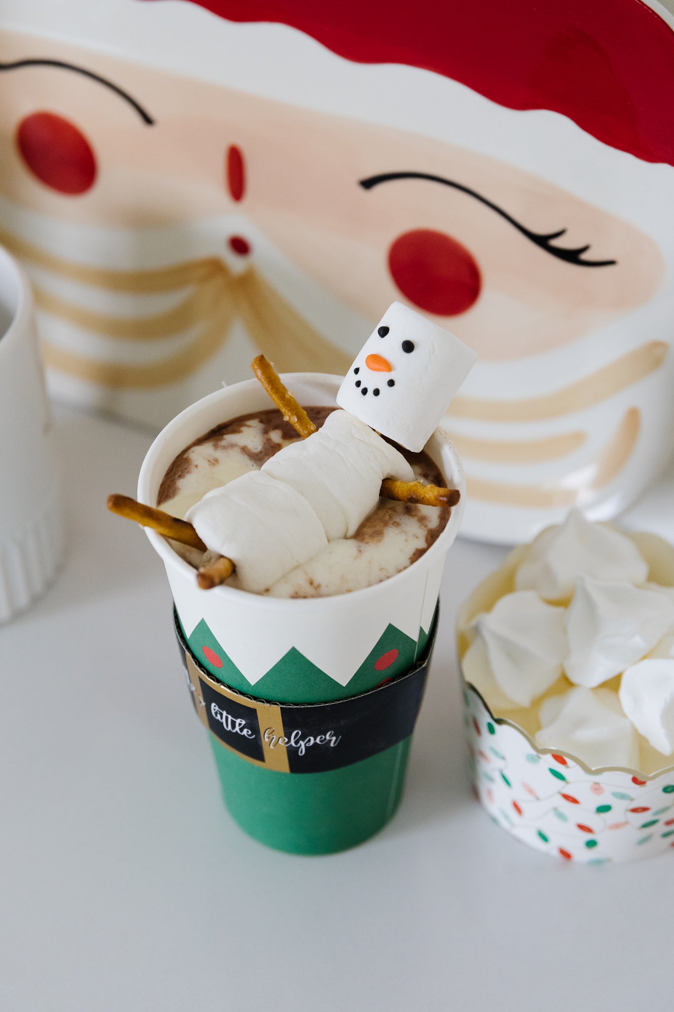 Snowman marshmallow in a Christmas hot chocolate cup. 