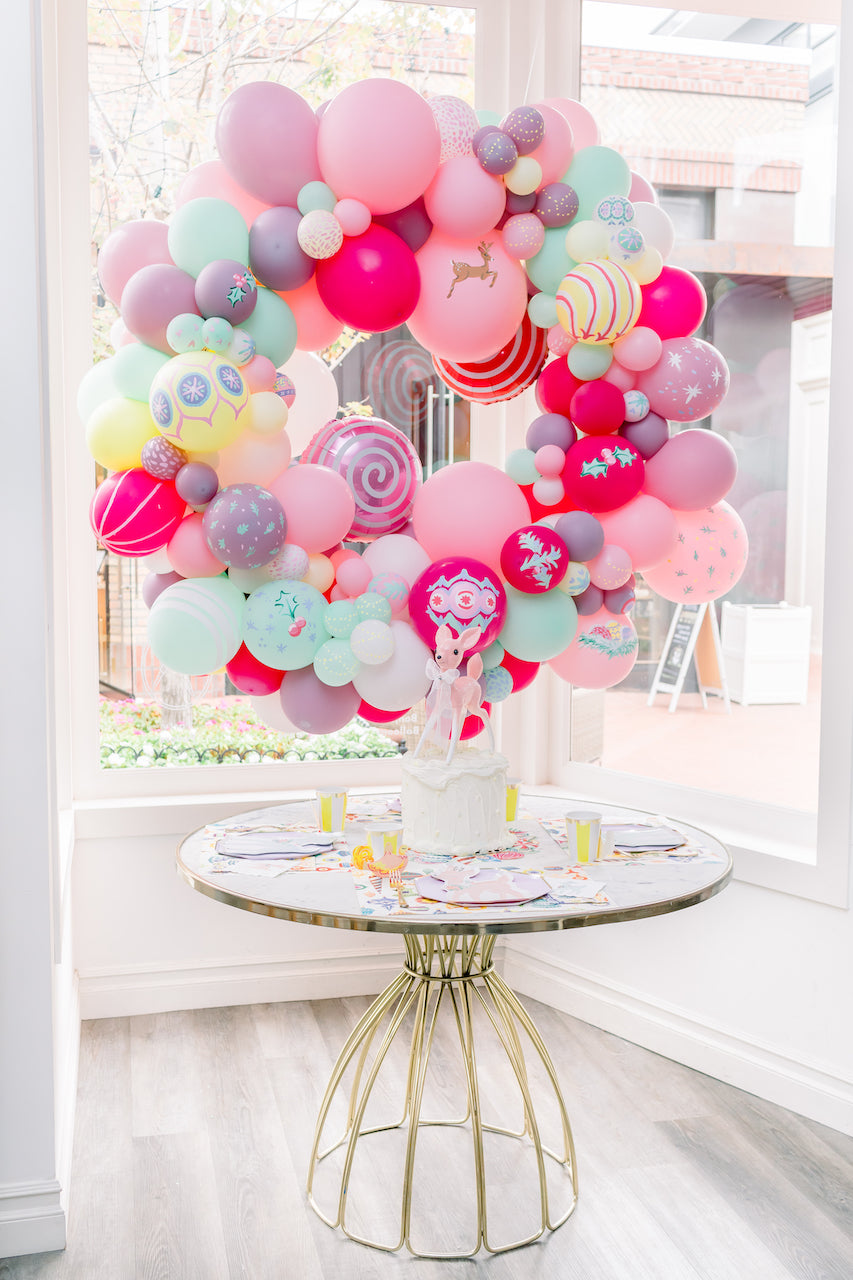 Bright and colorful balloon arch for a Christmas party.