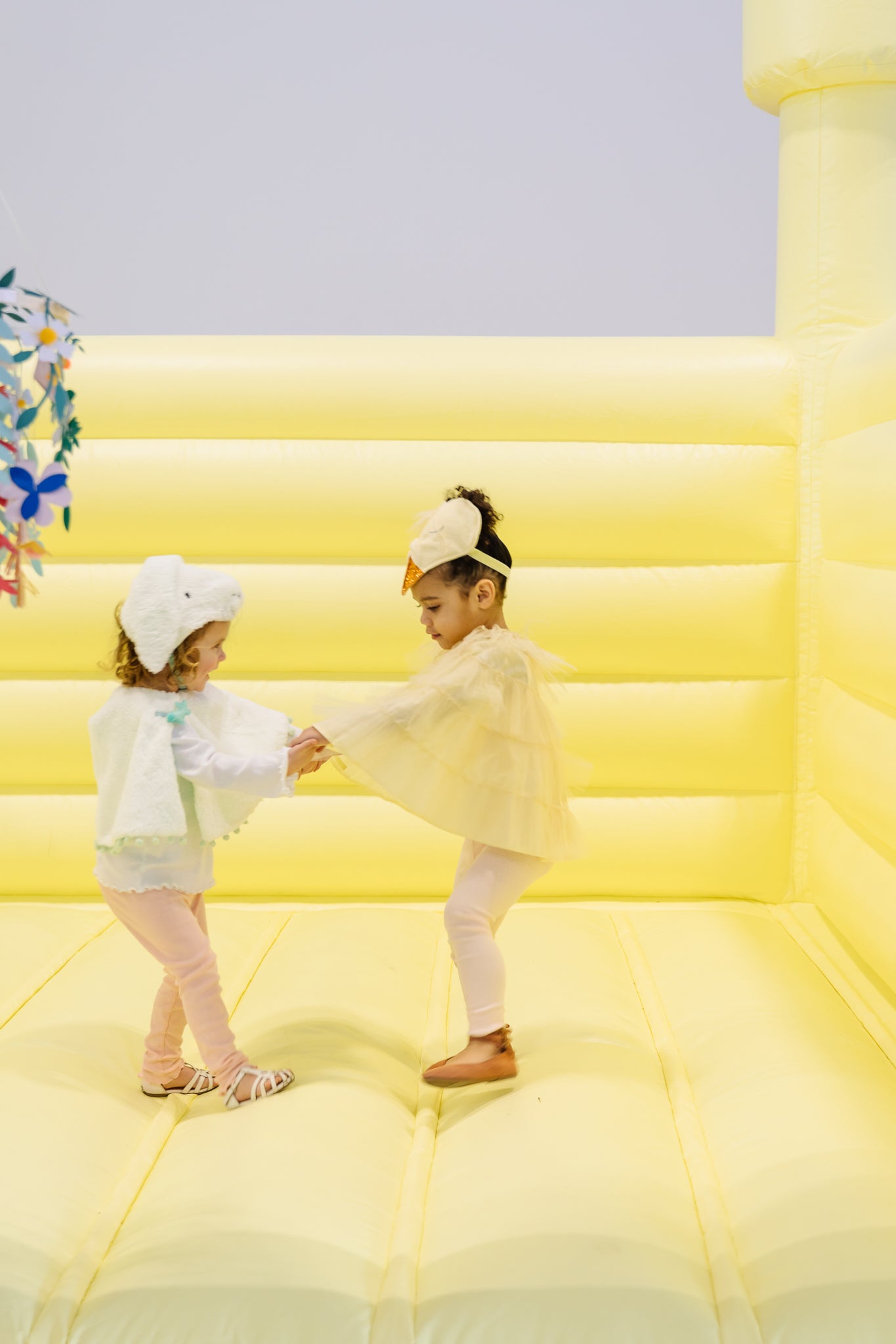 Kid's having fun in bounce house at Easter party.