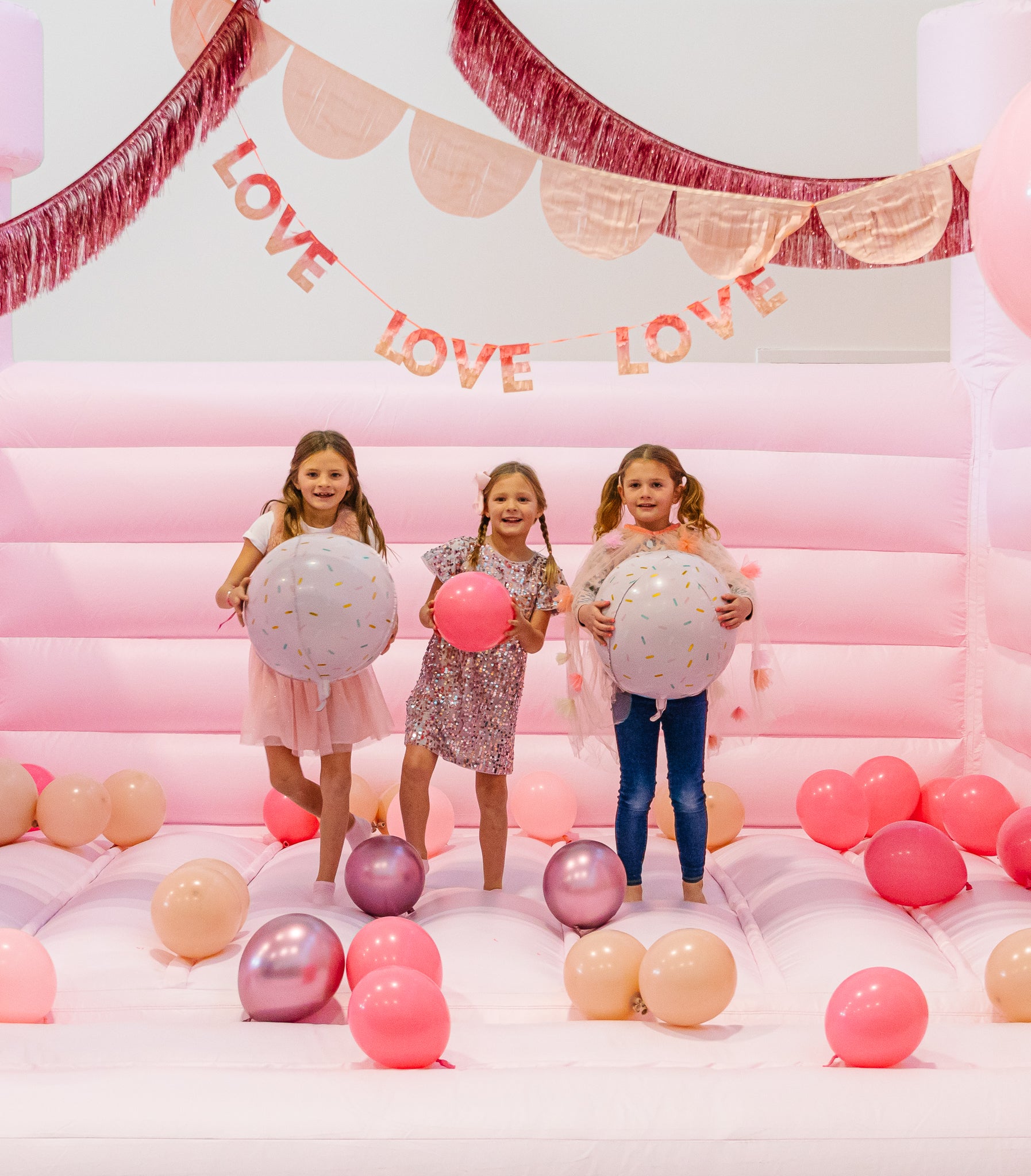 Pink bounce house for a fun kids Valentine's Day party
