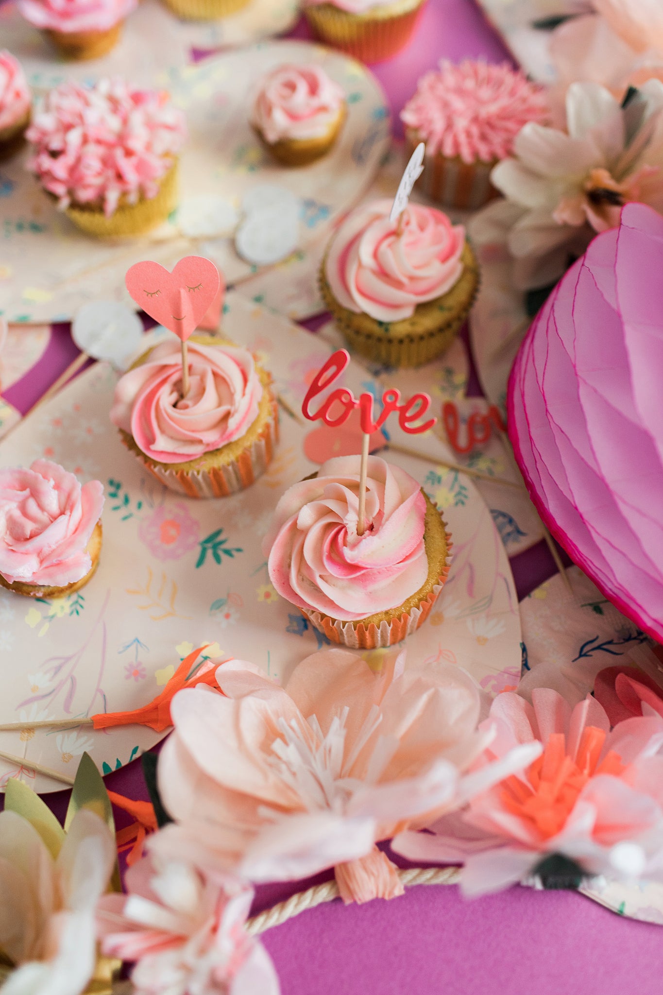 Pink Valentine's Day cupcakes with heart shaped toppers