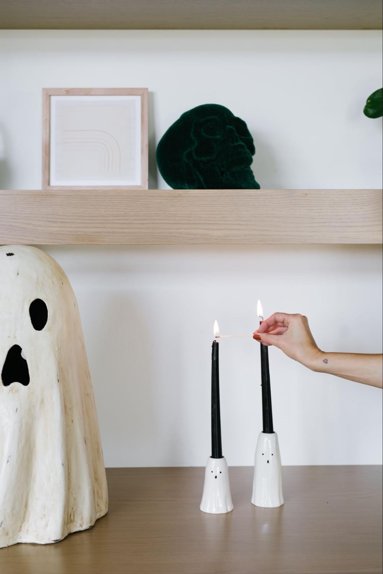 Ghost candle holders used as Halloween home decor.