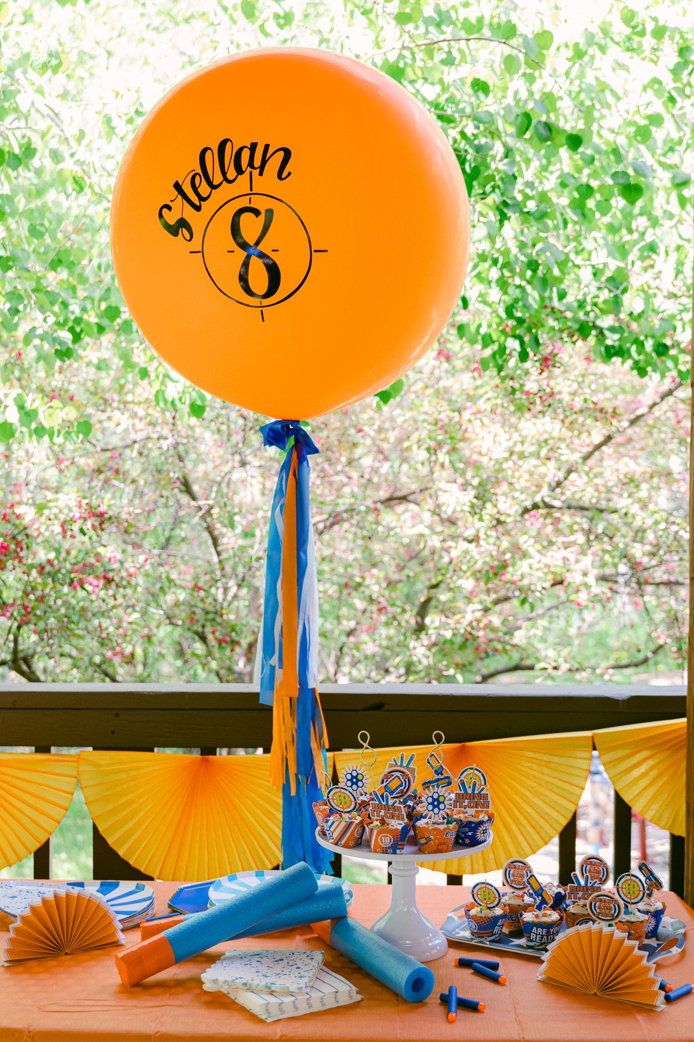 Nerf birthday party ideas using jumbo balloons and orange and blue decorations.