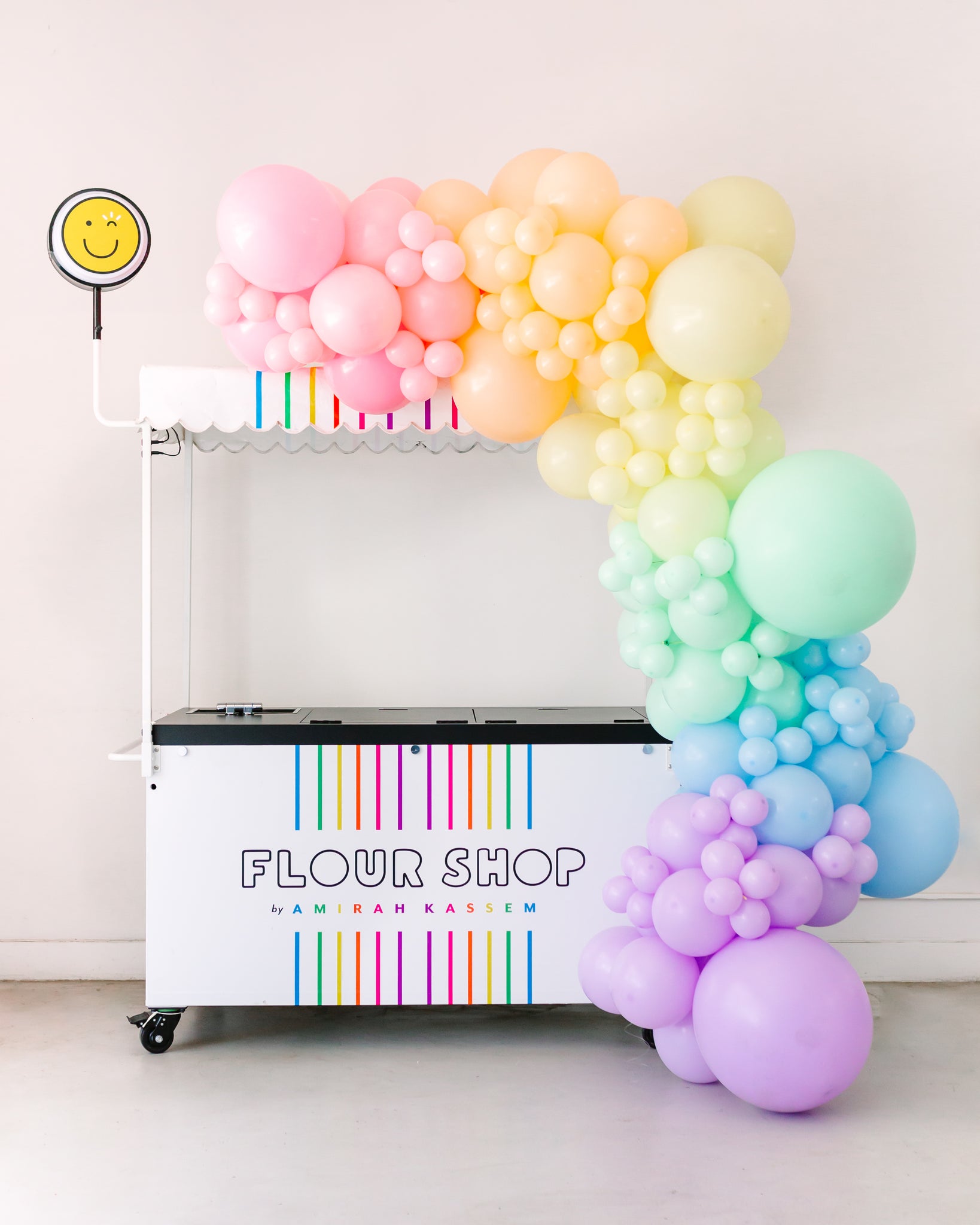 Pastel rainbow balloon garland decoration for a dessert cart.