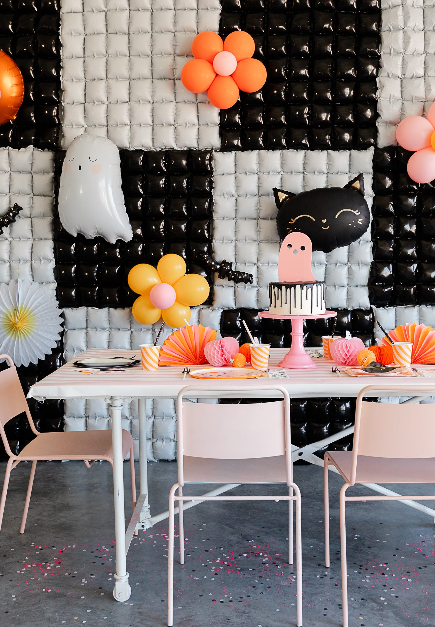 pink Halloween party set-up with waffle panel balloons.
