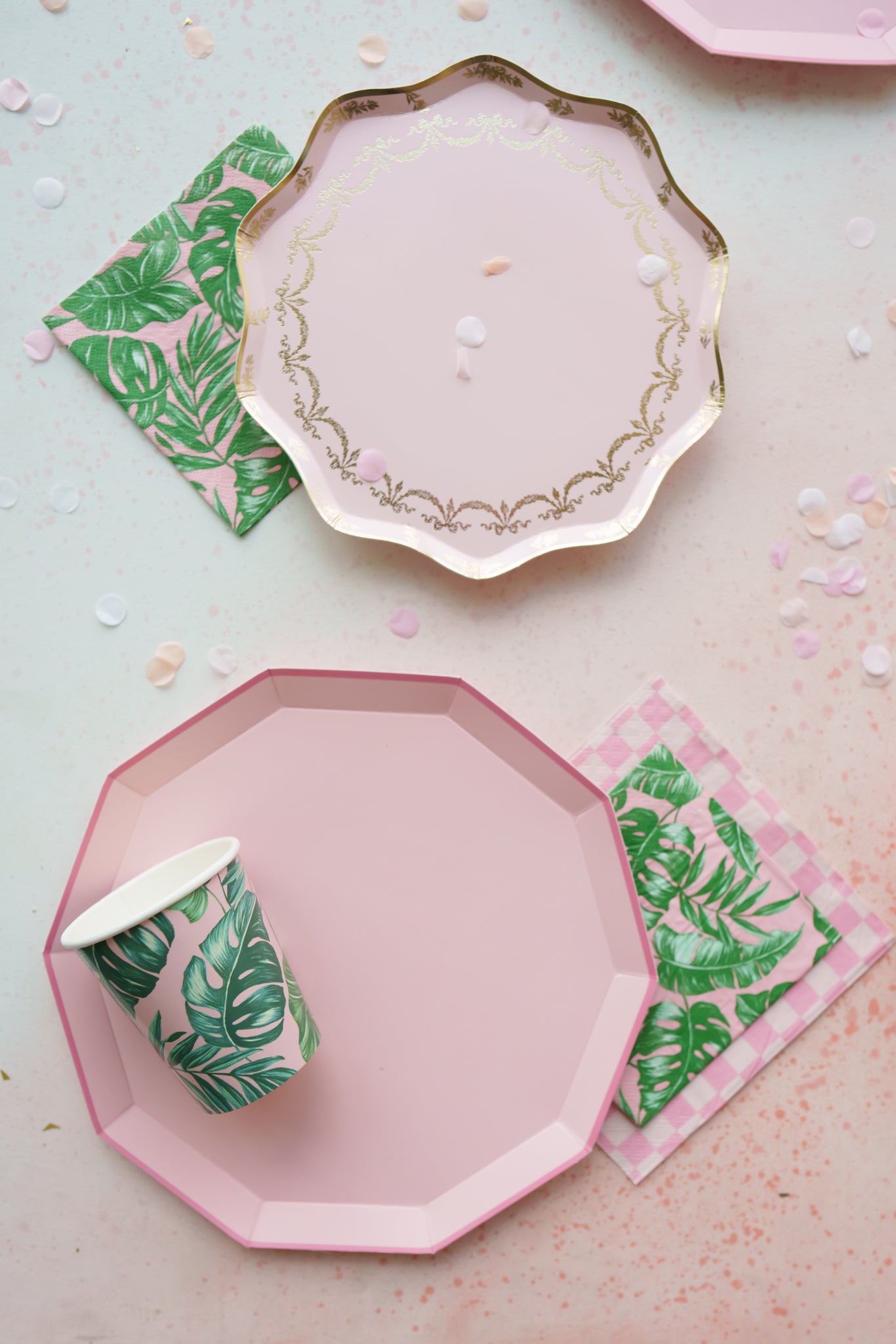 Pink party plates to use for a tropical theme adult birthday party.