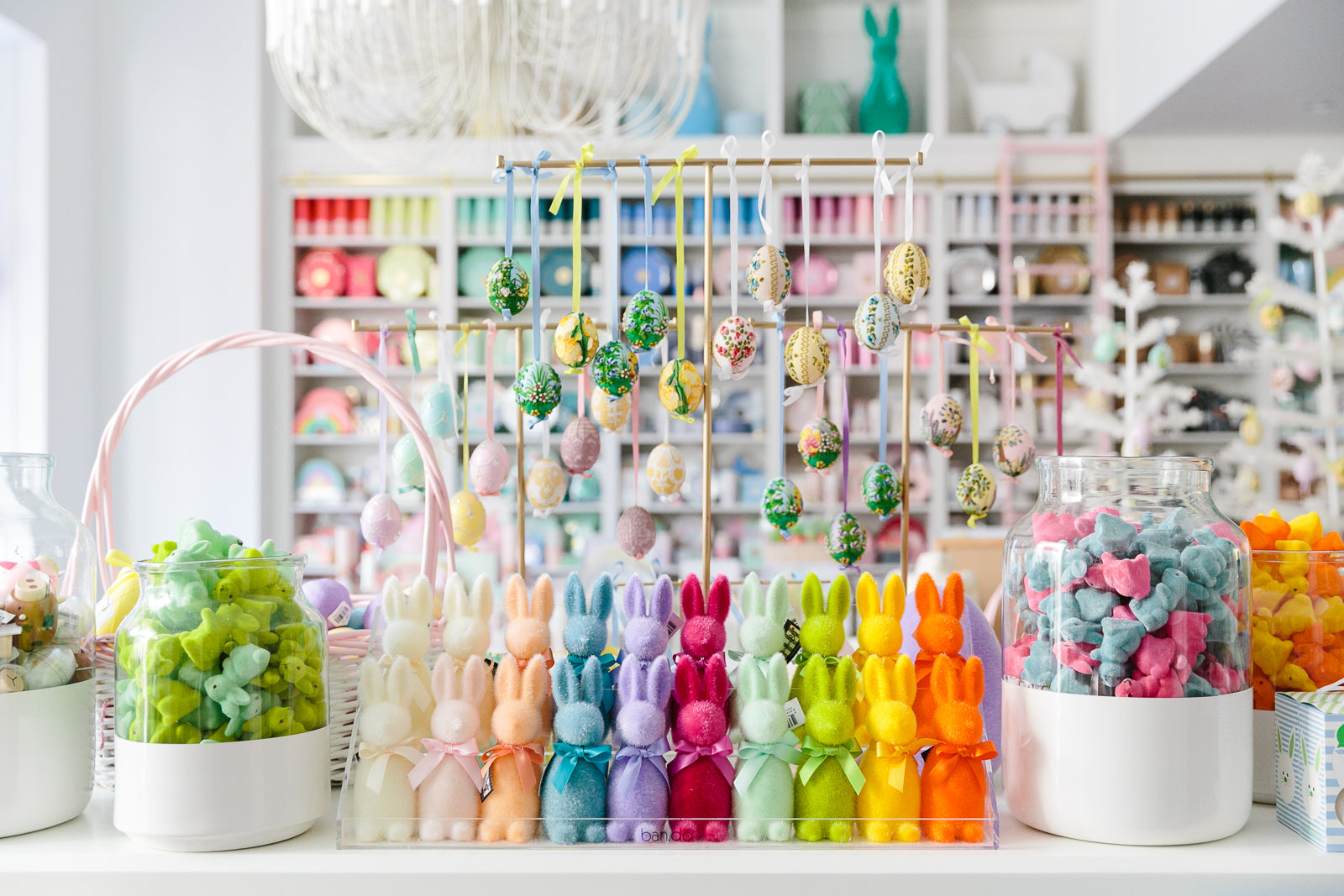 Rainbow flocked Easter bunnies displayed alongside other Easter decoration ideas at Bonjour Fête.