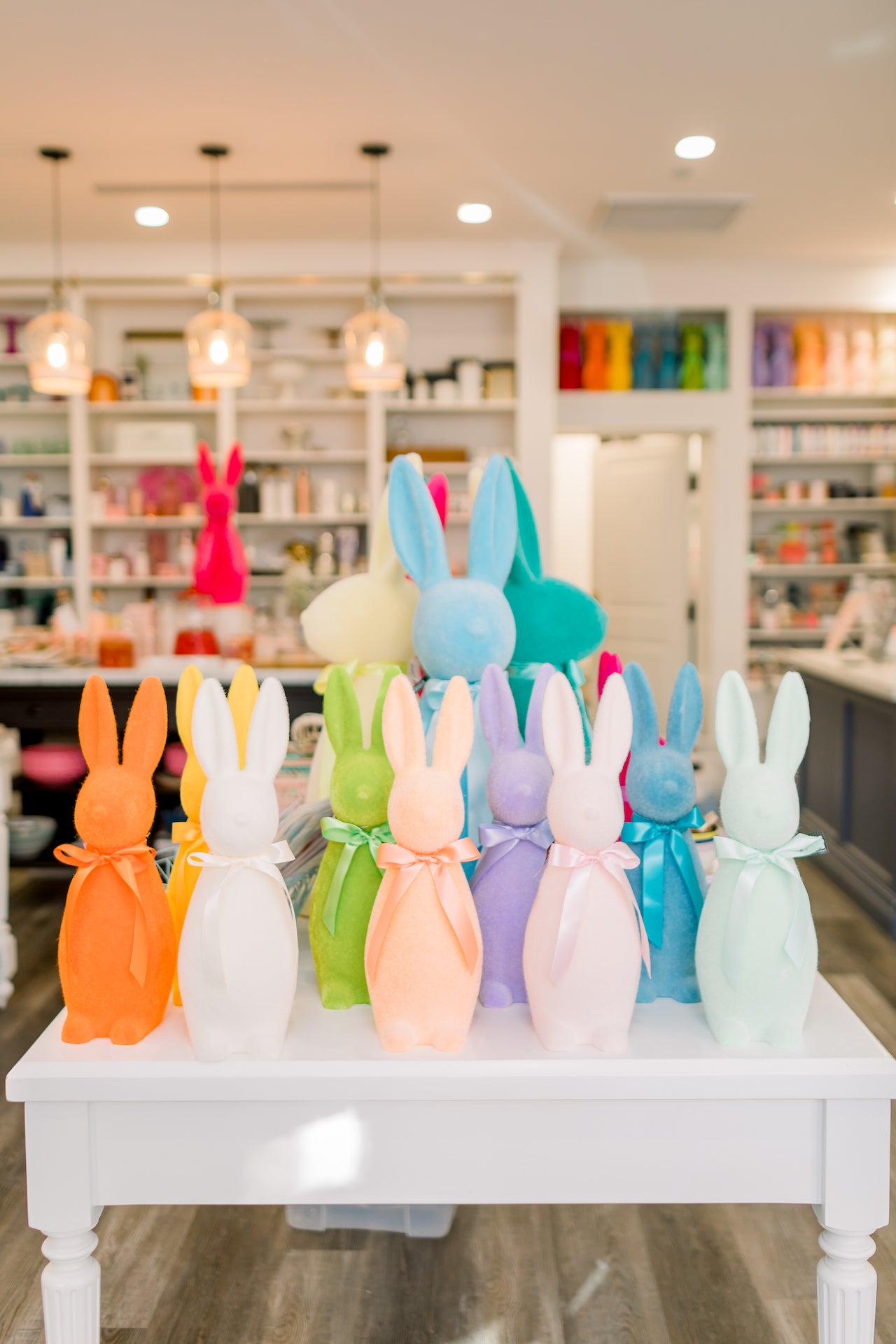 Bright flocked bunny decorations displayed at Bonjour Fête. 