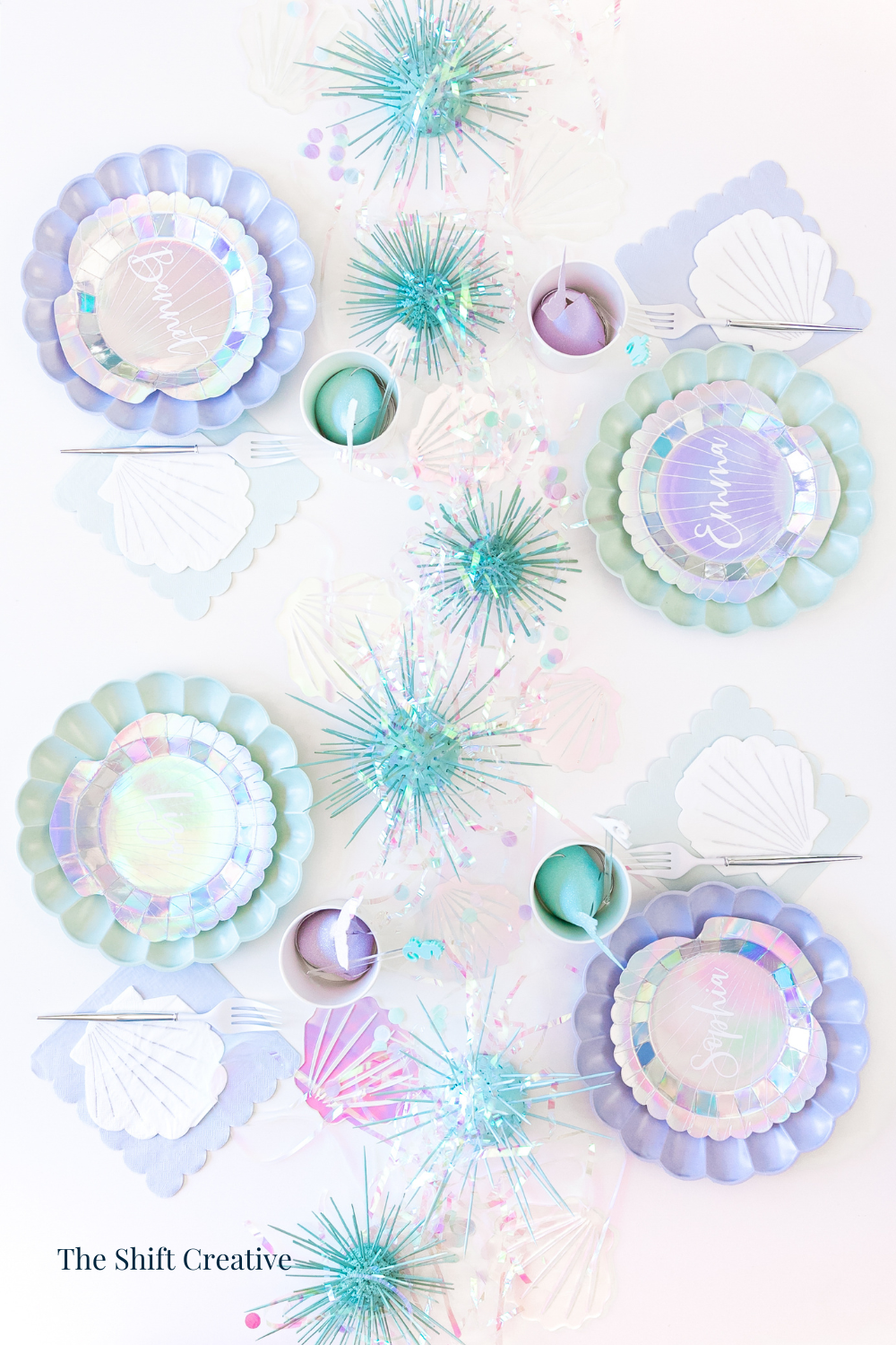 Mermaid birthday party tablescape ideas with iridescent party plates.