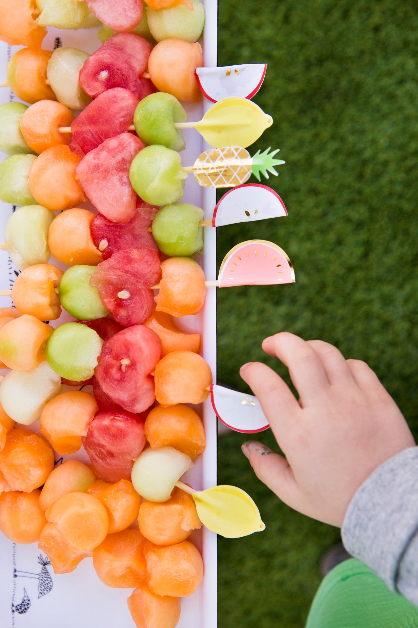 Rainbow party food ideas using fruit skewers.