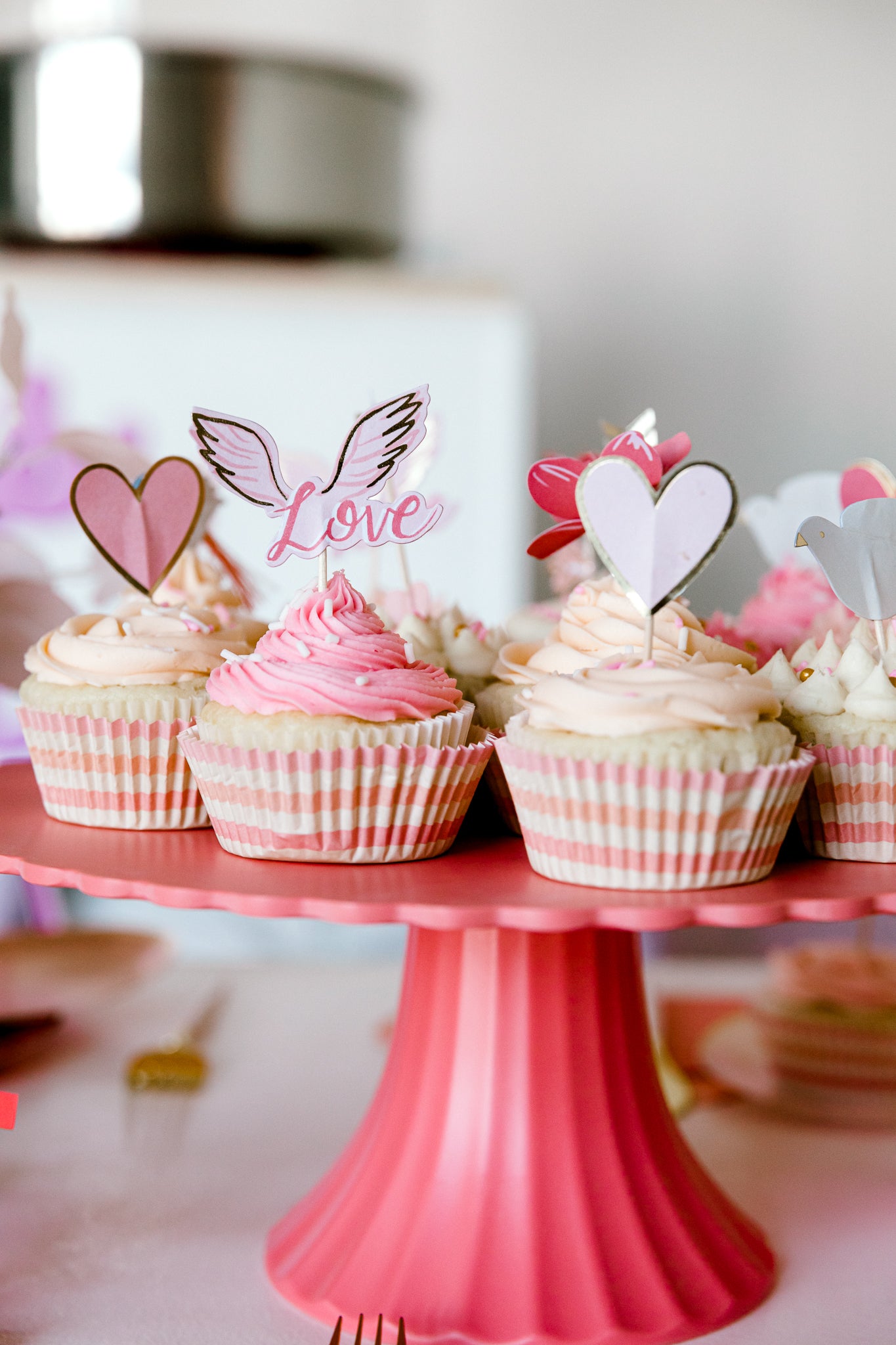 Valentine's Day cupcakes with themed toppers and tins