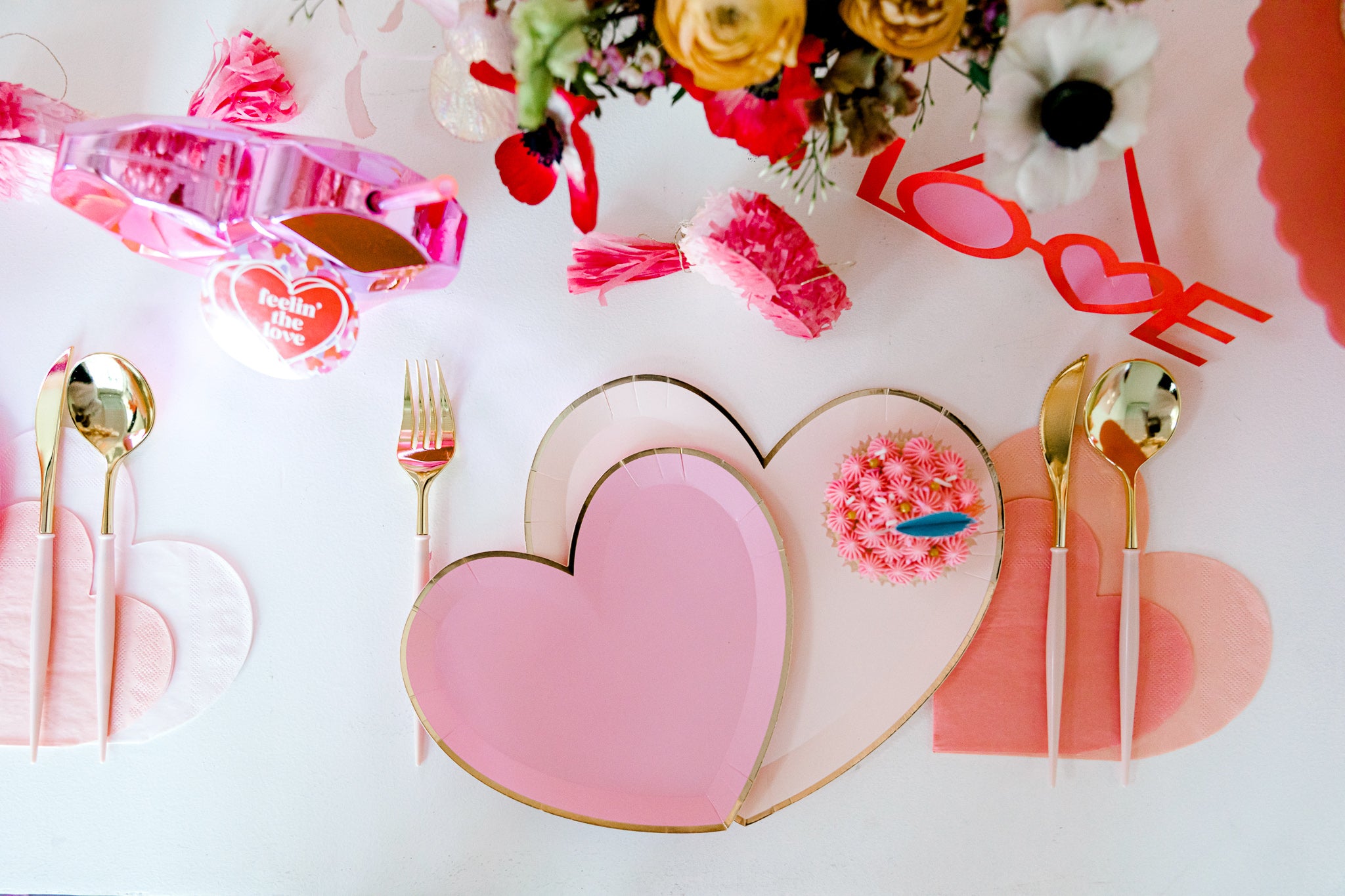 Pink table setting with heart shaped plates and napkins