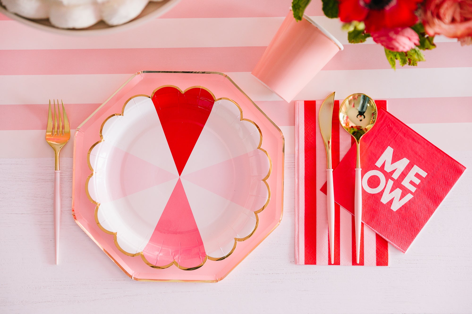 Red and pink striped plates and napkins with other Valentine's Day themed tableware