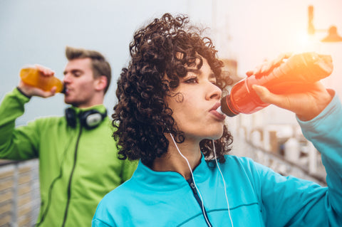 woman hydrating after run