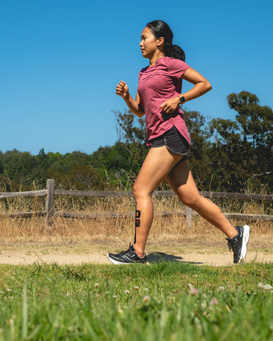 woman running with kt tape support for shin splints