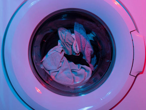 what is a laundry detergent? laundry being washed in a washing machine using detergent