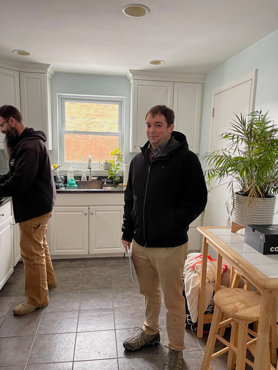 2 men standing in a kitchen 