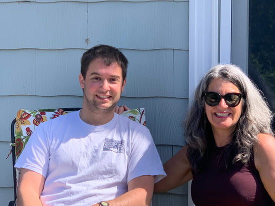 young man and his mom who has sunglasses on 