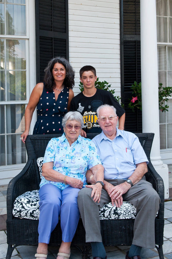 grandparents wtih daughter and grandson standing behind them