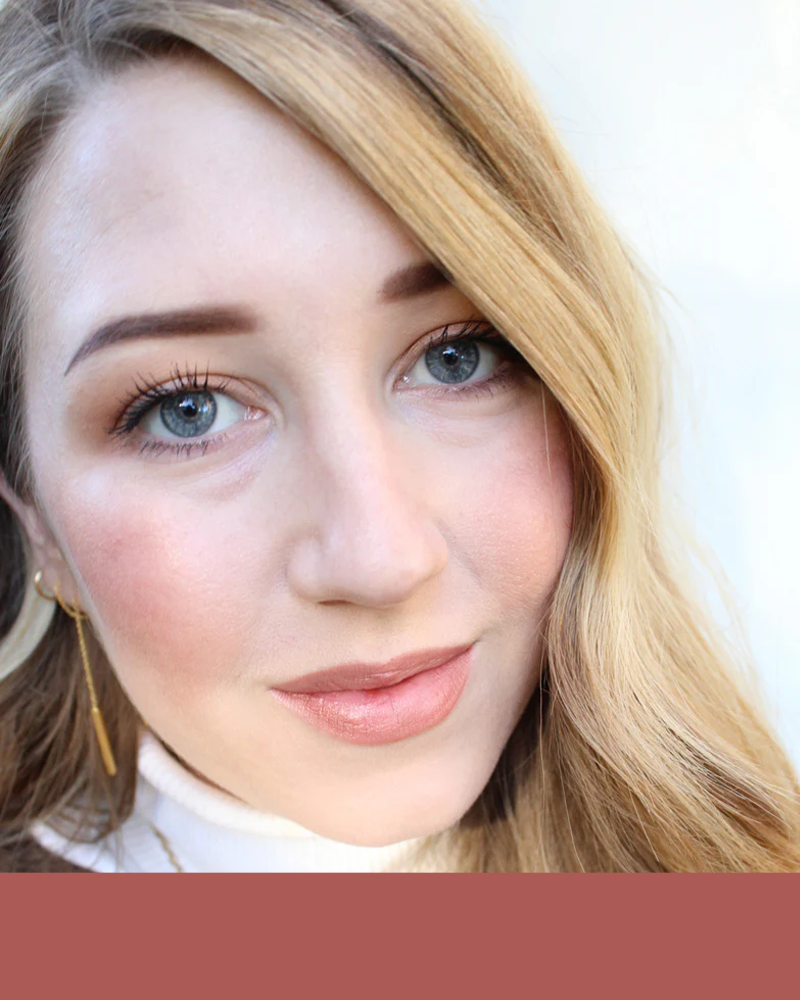 Close-up of a person with blonde hair, blue eyes, and light makeup.