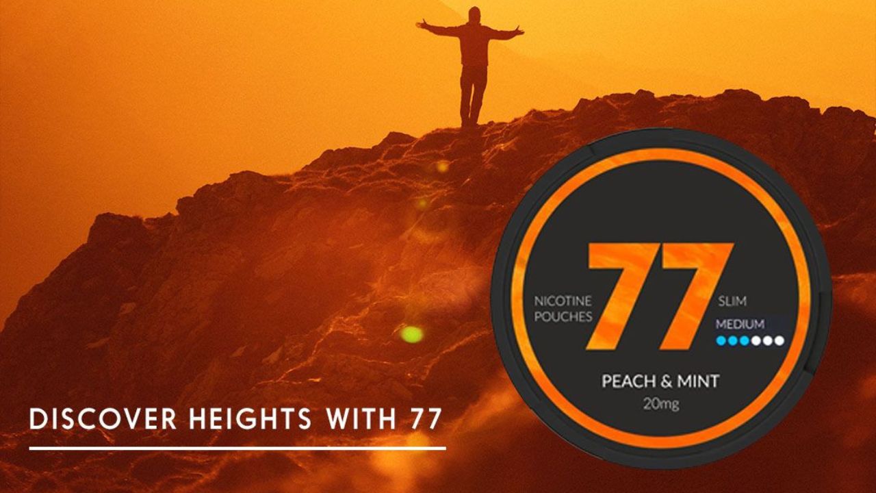 A bright, vibrant orange scenery ofa mountain with a person standing on top and in the foreground a tin of 77 nicotine pouches Tropical Flavor.