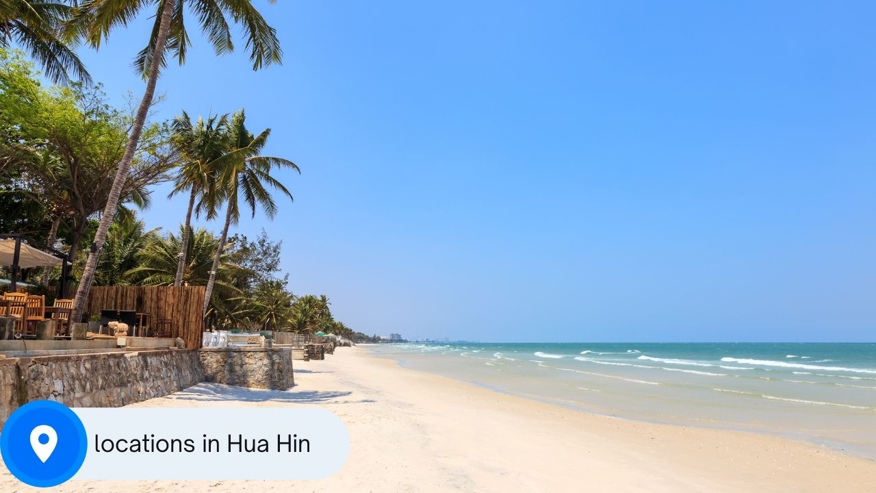 A picture of a beach in Hua Hin with a location sign with the words "locations in Hua Hin" written on it.