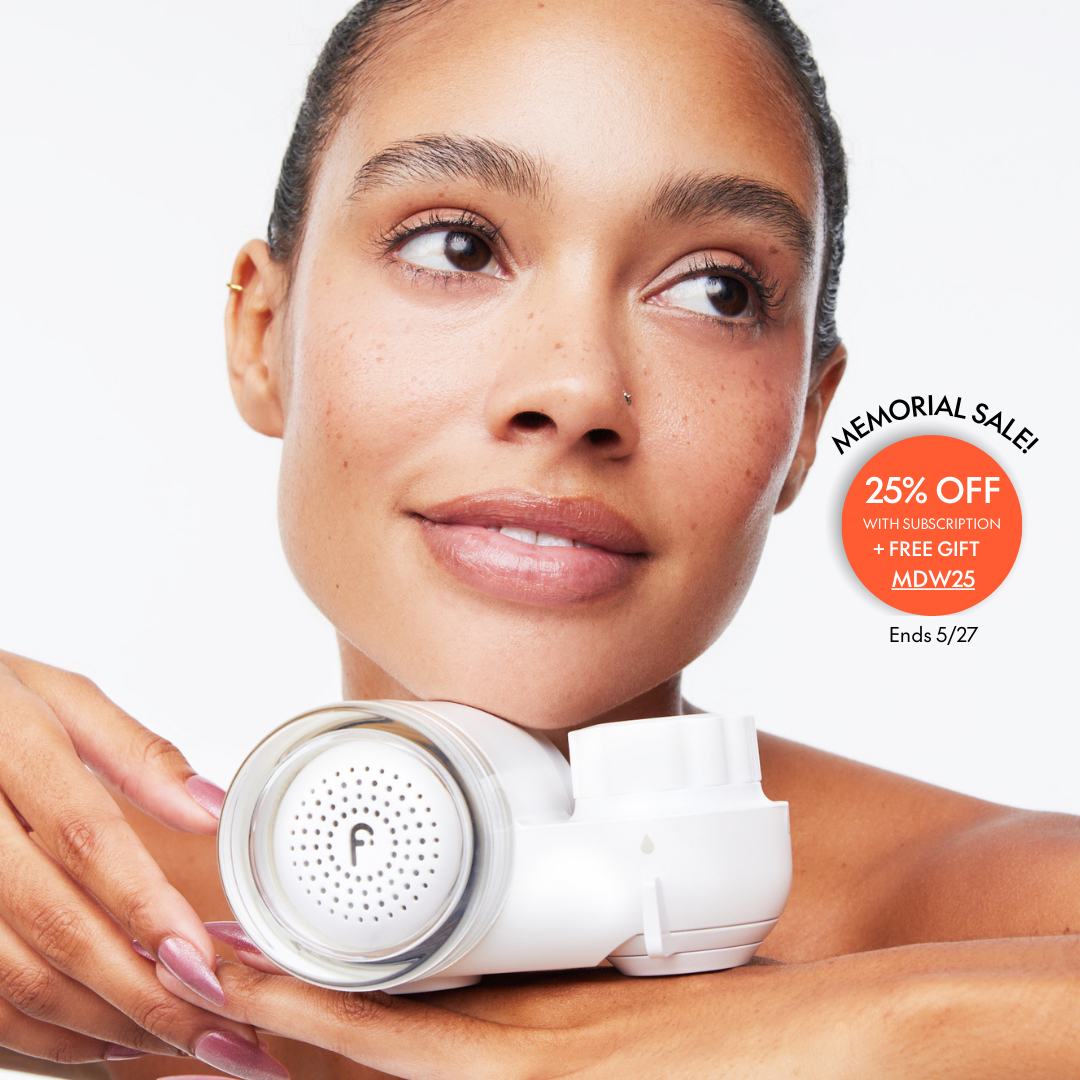 Woman holding a skincare device, with promotional text for a memorial sale.
