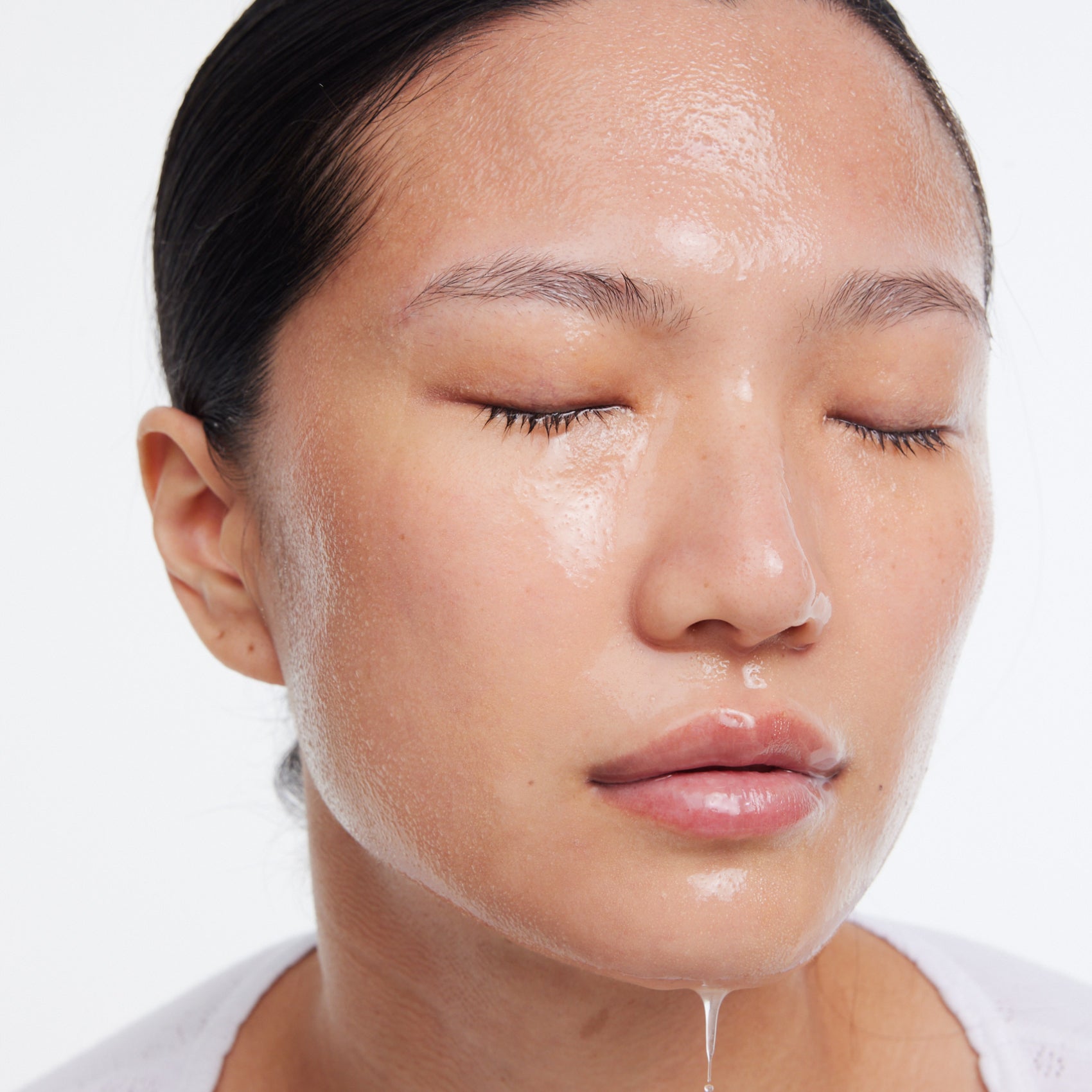 Close-up of a person's face with dewy, hydrated skin.