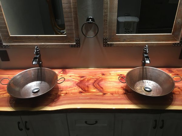 A wooden bathroom countertop renovated with an epoxy finish.