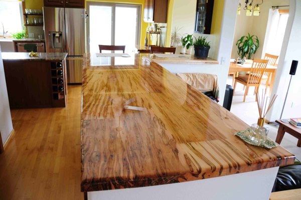 A wooden epoxy countertop in a well-lit room.