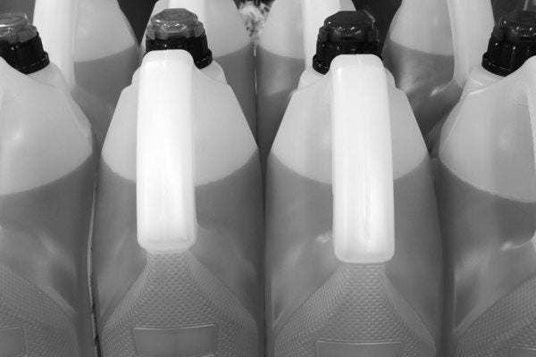 An array of unlabeled plastic bottles of resin.