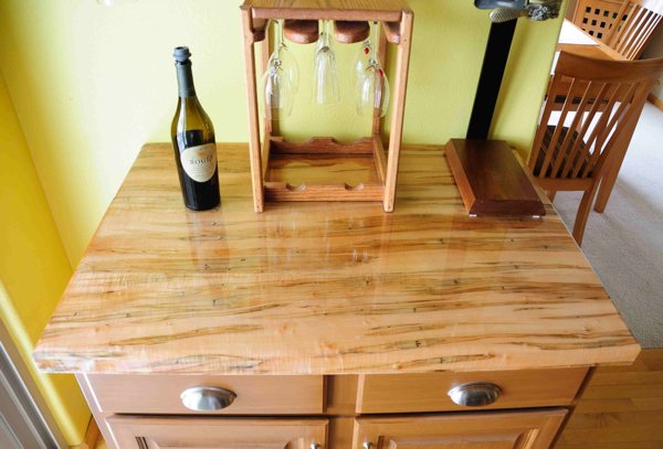 A wooden epoxy table top with several items resting atop it.