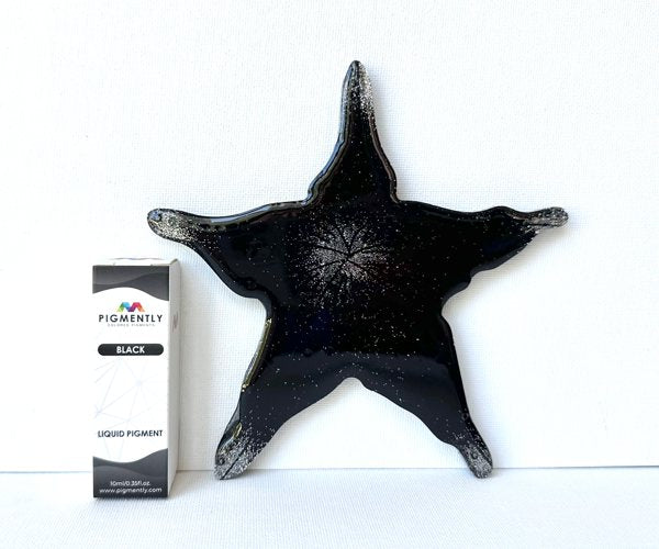 A epoxy resin art piece shaped like an abstract star. The resin has been tinted with Black Liquid Pigment from Pigmently